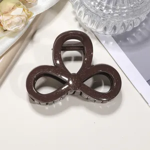 Detailed view of mocha brown glitter hair claw clip with triple hollow loop design