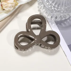 Elegant bow-shaped shark hair clip with glitter finish for thin hair styling