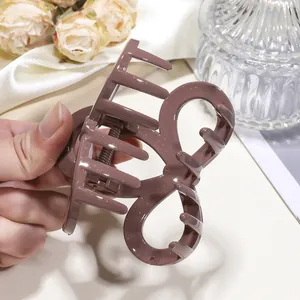 Sparkly mauve bow shark hair clip with a hollow streamlined design for women's hairstyles
