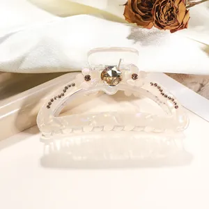 Detail showing 9cm cream hair claw clip with crystal flowers and amber gemstone decoration