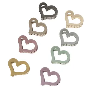 Set of 7 matte heart-shaped hair claw clips in assorted Morandi colors on white background