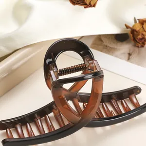 Close-up of large tortoiseshell resin hair claw clip with strong metal spring for thick hair
