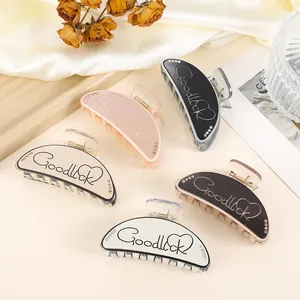 Detailed set of 5 colorful matte hair claws with Goodluck script and rhinestones