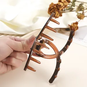 Detailed close-up of large amber gradient hair claw clip with strong metal spring