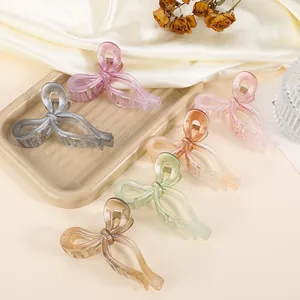 Close-up of butterfly hair claws in multiple colors like lavender and amber on silk fabric