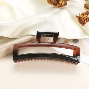 Detail of large rectangular claw clip with tortoiseshell gradient on silk fabric