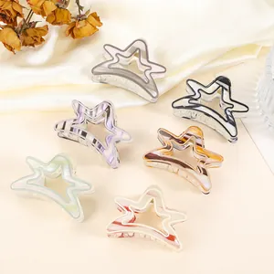 Detailed set of six colorful star-shaped hair claws on silk background with decor