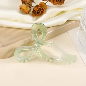 Translucent sage green acetate butterfly hair claw clip for elegant hairstyles
