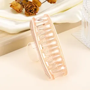 Detail of 9cm champagne hair claw clip with rhinestones and pearlescent finish
