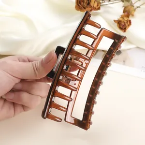 Detail of a large amber hair claw clip with strong spring and model Z-037 engraving