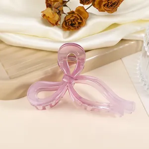 Macro view of butterfly acetate hair claw clip in translucent lavender with silk backdrop