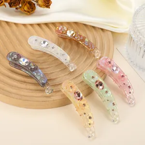 Set of six colorful iridescent banana hair clips with crystal and floral decorations