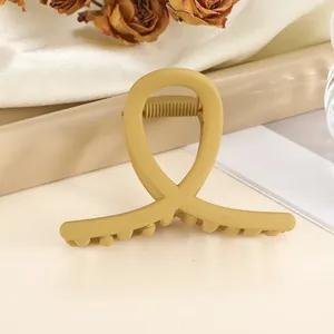 Detail of 7cm matte mustard yellow hair claw clip with non-slip teeth and metal spring