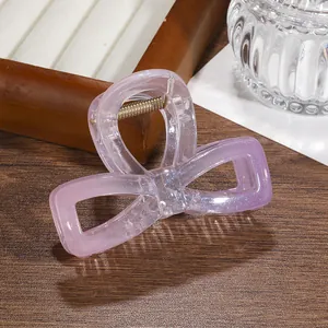 Detail of lavender glitter hair claw clip with transparent finish and metal spring