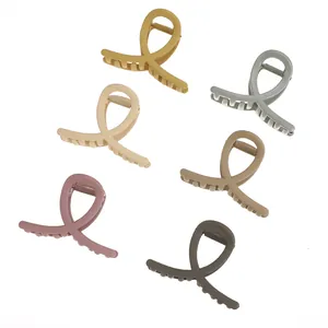 Set of 6 medium matte hair claws in various Morandi colors with minimalist cross design