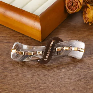 Detail of vintage marble pattern acetate hair clip with amber crystals and rhinestones