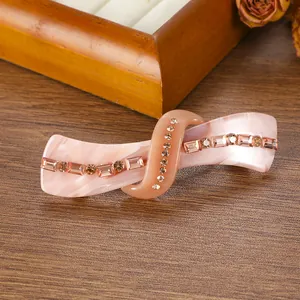 Detail of pink marble acetate spring hair clip with sparkling champagne rhinestones
