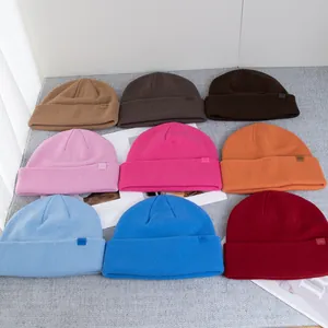 Collection of warm wool knit beanies in nine vibrant colors with a folded cuff design