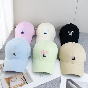 Set of pastel baseball caps with cute bear embroidery in pink, blue, and cream canvas