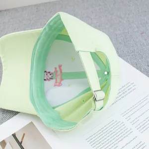 Top view of mint green cotton baseball cap showing internal stitching and metal buckle