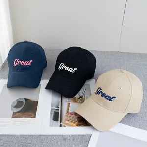 Three embroidered cotton baseball caps in navy, black and beige with Great lettering
