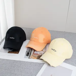 Distressed cotton baseball caps with smile embroidery in black, orange, and yellow colors