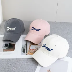 Detailed view of embroidered Great lettering on grey pink and white baseball caps