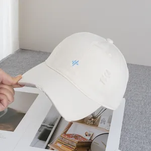 Detail of distressed brim and embroidery on a vintage style off-white baseball cap