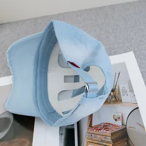 Close-up of light blue baseball cap with distressed brim and silver adjustable buckle