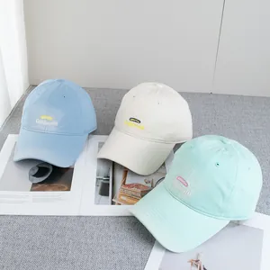 Detail of embroidered American vintage baseball caps in blue, cream and mint colors