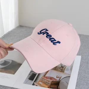 Close-up of pink cotton baseball cap featuring blue 'Great' letter embroidery detail