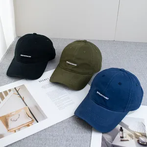 Three minimalist cotton baseball caps in black, olive green and navy blue with embroidery