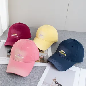 Retro distressed California baseball caps in four colors on a fashion magazine background