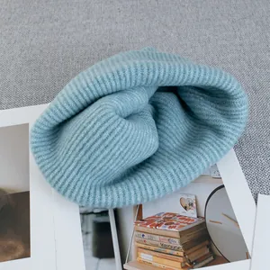 Cozy blue wool knit beanie for women in premium ribbed texture on a minimalist background