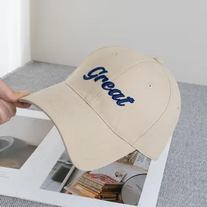 Detail of Great cursive embroidery on beige cotton twill baseball cap with reinforced brim