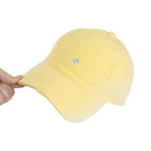 Distressed pale yellow cotton baseball cap with blue embroidery and vintage detailing