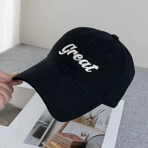 Detail of Great cursive embroidery on a black cotton baseball cap with curved brim