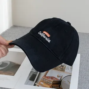 Close-up of distressed brim details and California embroidery on a black baseball cap