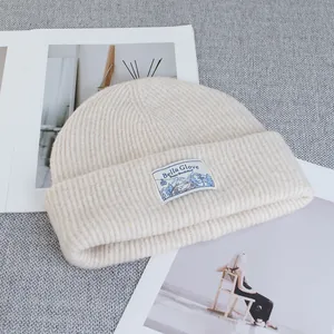 Detailed view of the soft knitted texture and woven label on a winter wool beanie hat