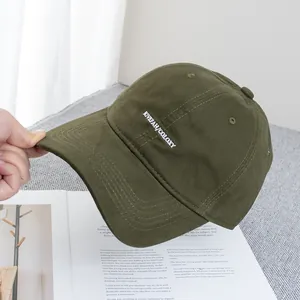 Close-up of olive green baseball cap with white KIVEZAH COLOXY letter embroidery