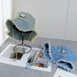 Denim bucket hat with cute cat embroidery and frayed brim for sun protection