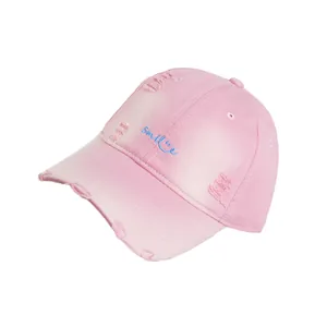 Distressed pink cotton baseball cap with blue Smile embroidery and vintage worn details