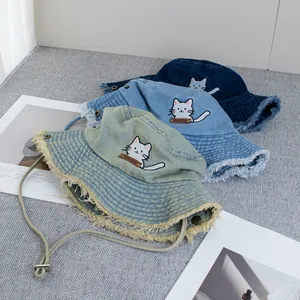 Denim bucket hat with cat embroidery, wide frayed brim and adjustable windproof rope