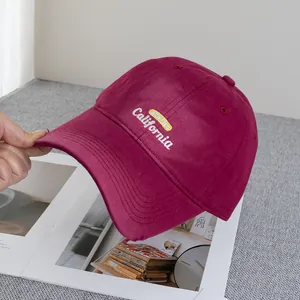 Close-up of burgundy distressed baseball cap featuring white California 3D embroidery