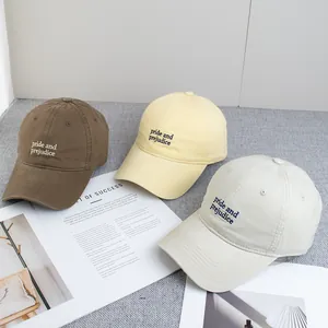 Three cotton baseball caps in brown, cream and beige with pride and prejudice embroidery