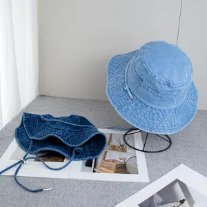 Denim bucket hats in light and dark blue with adjustable drawstrings for sun protection