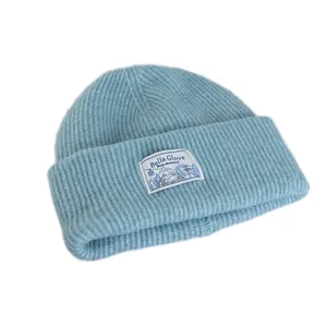 Light blue wool blend knit beanie with decorative winter wonderland patch on front