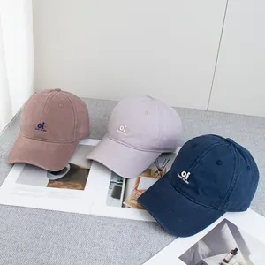Minimalist cotton baseball caps with 'oi look at me' embroidery in multiple colors