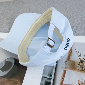 Detail of light blue baseball cap with cube embroidery and metal adjustable strap