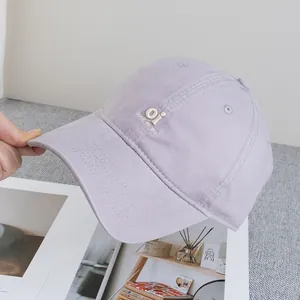 Close-up of lavender baseball cap with white embroidered oi and look at me text